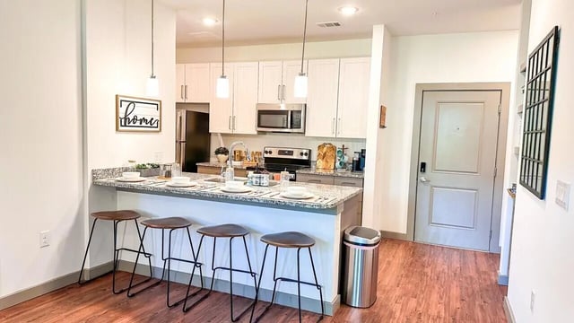 Stools and kitchen island with plates kitchen at 14 SixtyFive in Kennesaw Student Accommodation