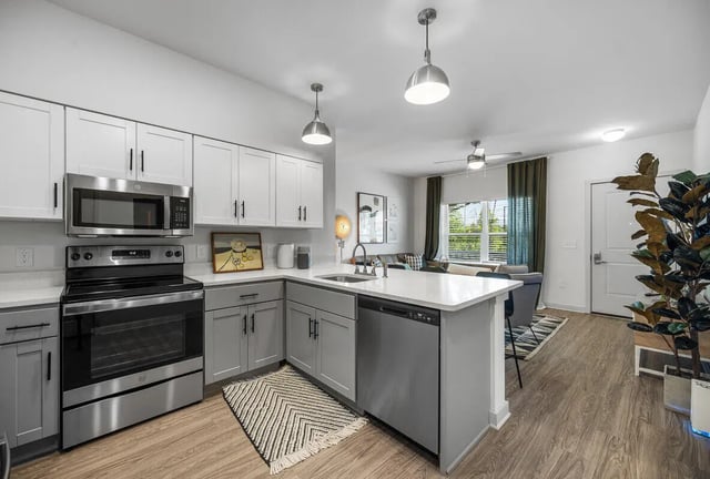 Modern student kitchen with stainless steel appliances living room kitchen at Aspen Heights University City in Charlotte Student Accommodation