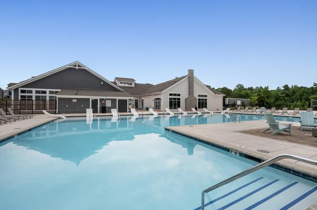 Large swimming pool with lounge chairs and building exterior Pool exterior at Aspen Heights University City in Charlotte Student Accommodation
