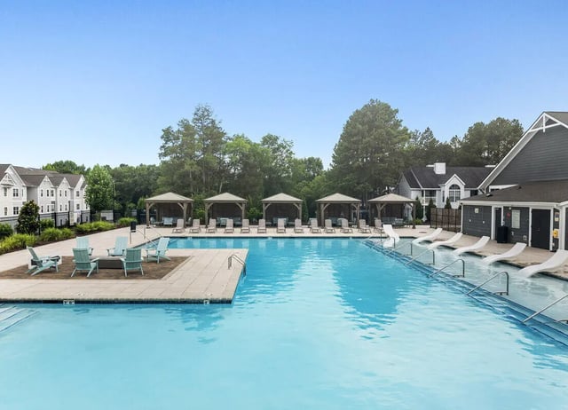 Pool with lounge chairs cabanas and buildings exterior at Aspen Heights University City in Charlotte Student Accommodation