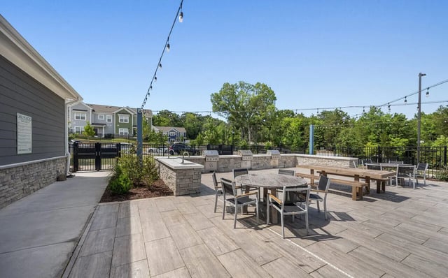 Grill area tables chairs and benches outdoor amenity area at Aspen Heights University City in Charlotte Student Accommodation