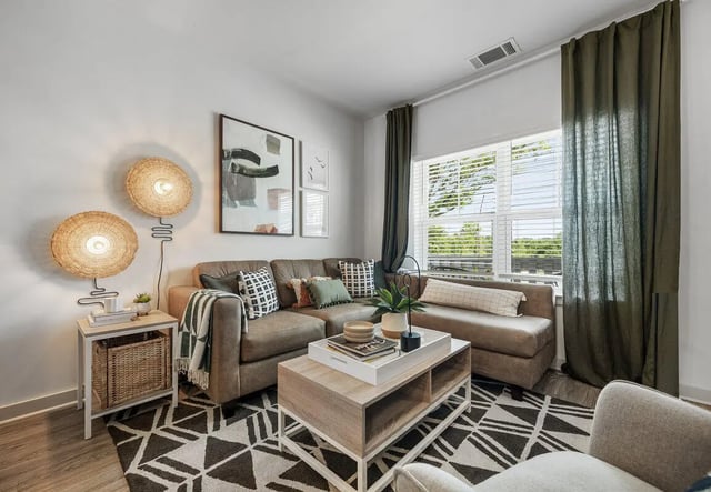 Brown sectional couch coffee table patterned rug living room at Aspen Heights University City in Charlotte Student Accommodation