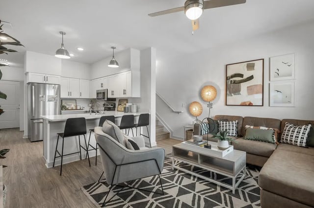 Kitchen island with stools living room with sofa living room at Aspen Heights University City in Charlotte Student Accommodation