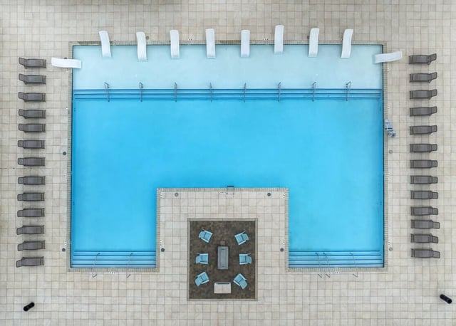 Pool with lounge chairs and seating area outdoor area at Aspen Heights University City in Charlotte Student Accommodation