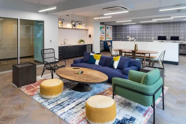 Blue couch oval table patterned rug living room at The Soto in Eugene Student Accommodation