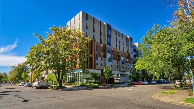 Modern apartment building with trees and cars exterior at The Soto in Eugene Student Accommodation