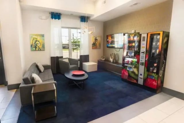 Sofa armchair coffee table vending machines TV lounge area at Aspen Springfield in Springfield Student Accommodation