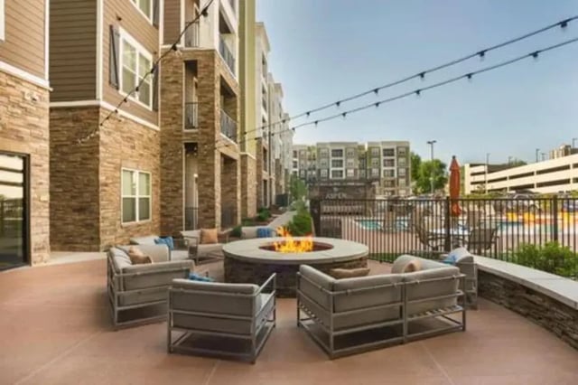 Fire pit with lounge seating near apartments exterior at Aspen Springfield in Springfield Student Accommodation