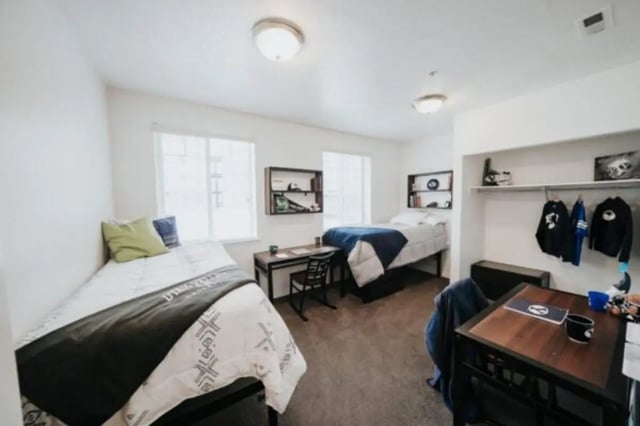Two beds desks and closet bedroom at Alpine Village in Provo Student Accommodation