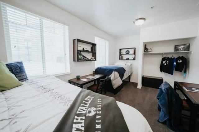 Two beds desks shelving and closet bedroom at Alpine Village in Provo Student Accommodation