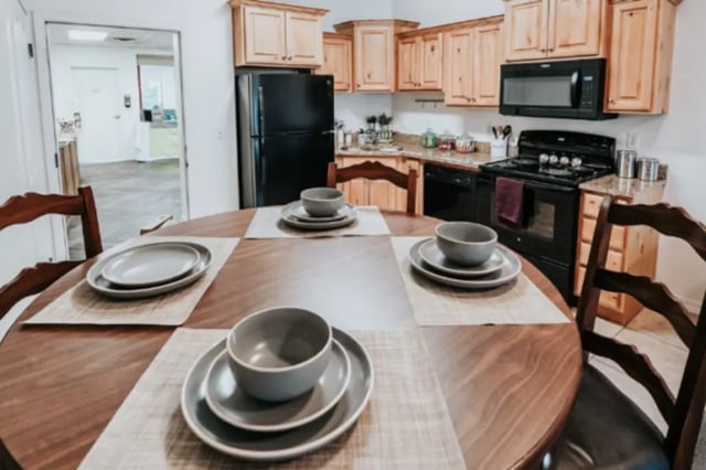 Table with place settings and kitchen background kitchen at Alpine Village in Provo Student Accommodation
