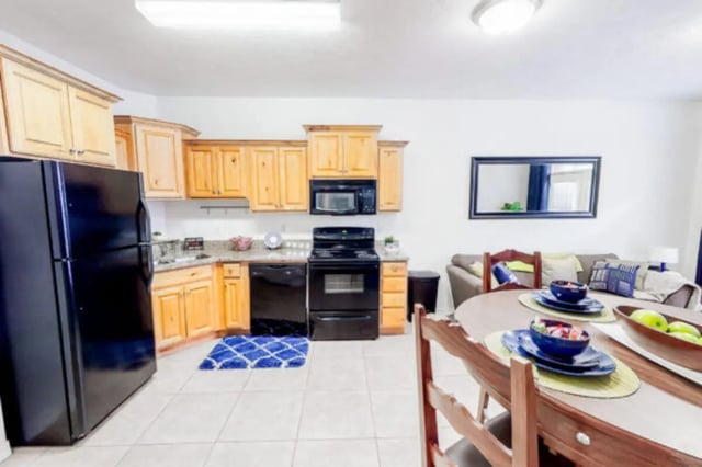 Black refrigerator wooden cabinets stove kitchen dining area living room exterior at Alpine Village in Provo Student Accommodation