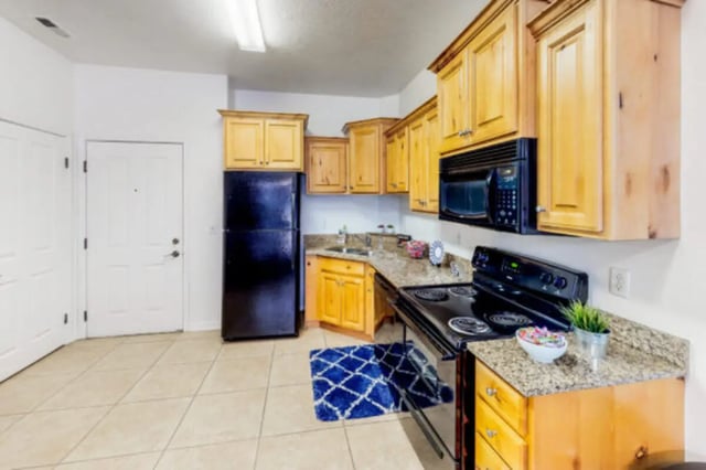 Black refrigerator wood cabinets granite countertop kitchen at Alpine Village in Provo Student Accommodation