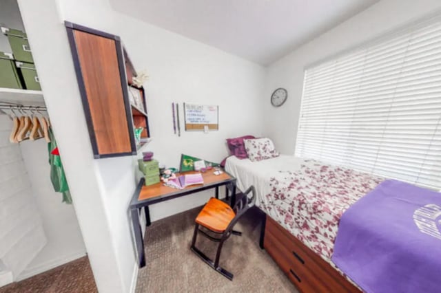 Desk and bed with floral linens bedroom at Alpine Village in Provo Student Accommodation