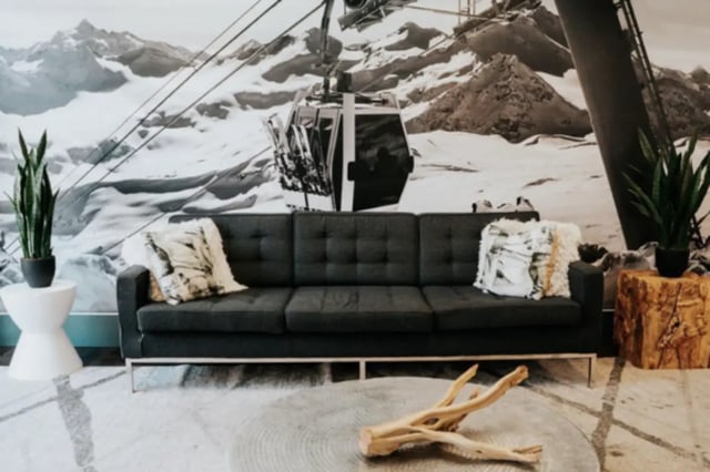 Dark sofa with pillows mountain mural living room at Alpine Village in Provo Student Accommodation