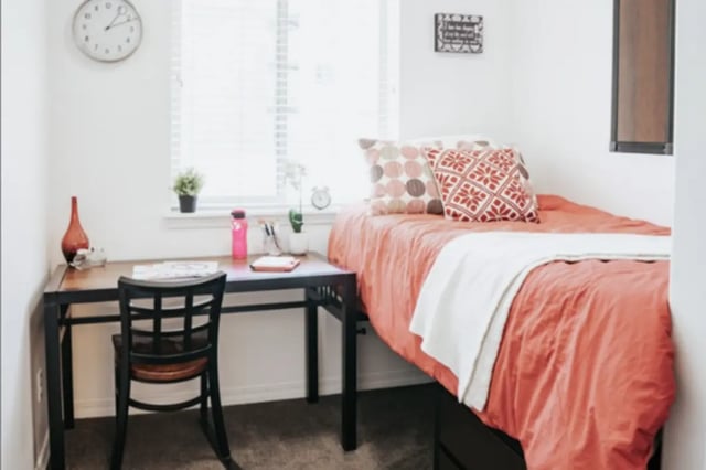 Bed desk chair pillows and decor bedroom at Alpine Village in Provo Student Accommodation