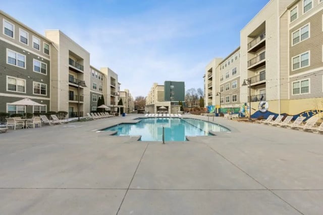 Apartment buildings surrounding a pool area exterior at The Harbor in Johnson City Student Accommodation