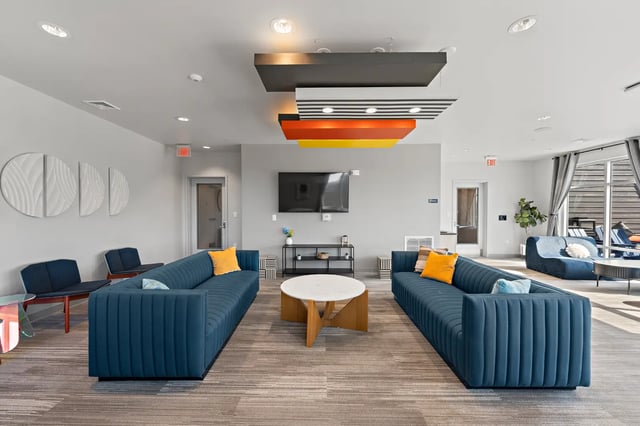 Blue sofas television and coffee table living room at Aspen State College in State College Student Accommodation