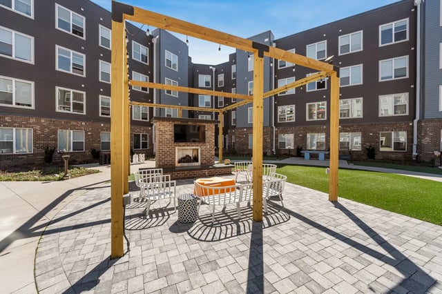 Courtyard with fireplace television and seating area exterior at Aspen State College in State College Student Accommodation