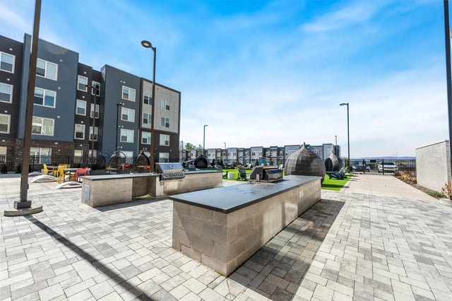 Grill stations outdoor seating apartment building exterior at Aspen State College in State College Student Accommodation