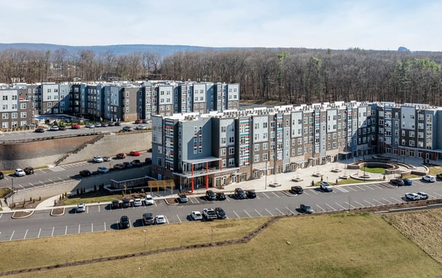 Modern apartment buildings with cars and parking lot Exterior at Aspen State College in State College Student Accommodation