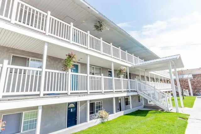 Apartment building with balconies stairs exterior at Birch Plaza and Birchwood Apartments in Rexburg Student Accommodation