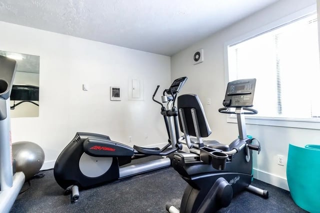 Elliptical bike treadmill exercise equipment gym at Birch Plaza and Birchwood Apartments in Rexburg Student Accommodation