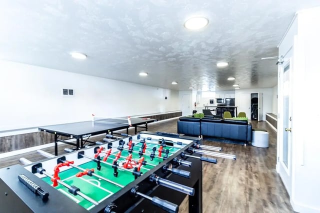 Foosball table ping pong tables black sofa living room at Birch Plaza and Birchwood Apartments in Rexburg Student Accommodation