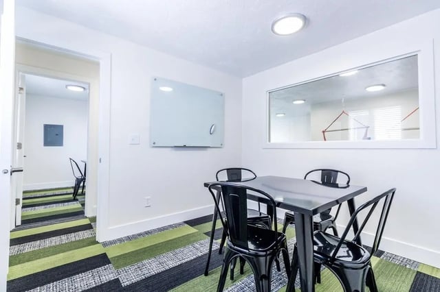 Table chairs and whiteboard study area at Birch Plaza and Birchwood Apartments in Rexburg Student Accommodation