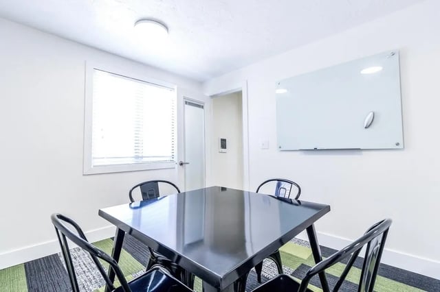 Black table chairs whiteboard study area at Birch Plaza and Birchwood Apartments in Rexburg Student Accommodation