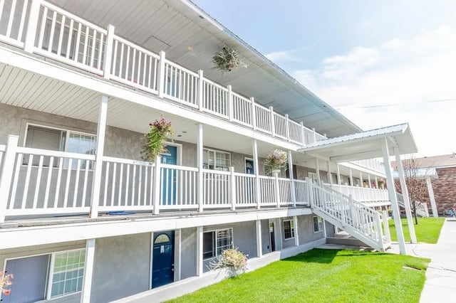 Apartment building with white railings balconies exterior at Birch Plaza and Birchwood Apartments in Rexburg Student Accommodation