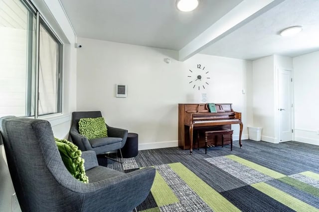 Chairs piano and clock common area at Birch Plaza and Birchwood Apartments in Rexburg Student Accommodation