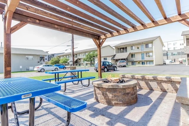 Picnic tables and fire pit exterior at Birch Plaza and Birchwood Apartments in Rexburg Student Accommodation