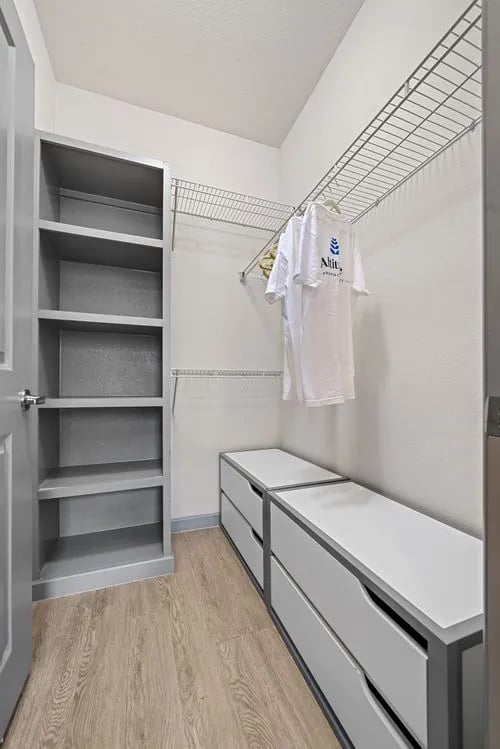 Shelves drawers and a hanging shirt closet at Altitude Apartments in Houston Student Accommodation