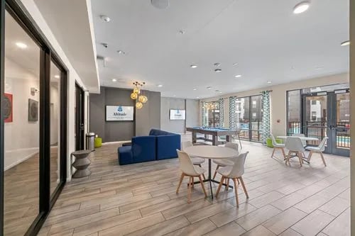 Pool table blue sofa seating area living room at Altitude Apartments in Houston Student Accommodation