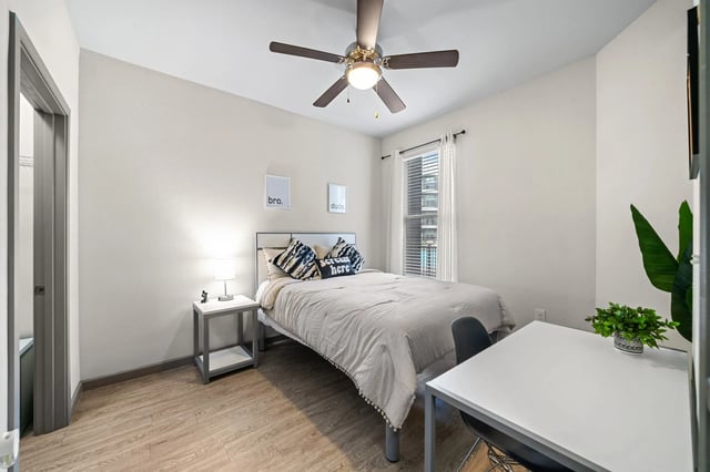 Bed bedside table desk and chair bedroom at Altitude Apartments in Houston Student Accommodation