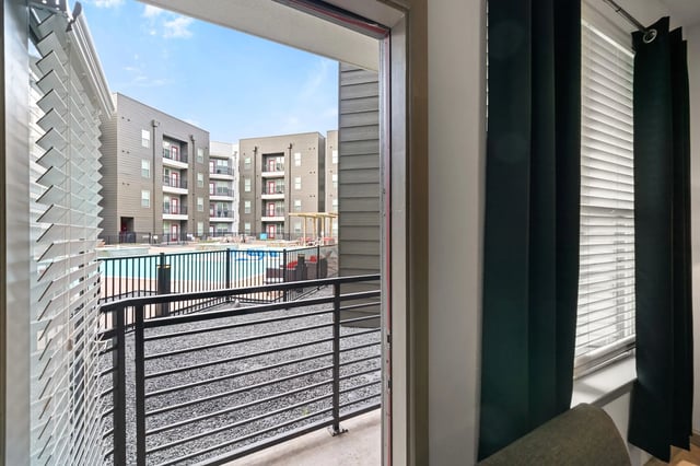 Apartment buildings with a pool and balcony exterior at Altitude Apartments in Houston Student Accommodation