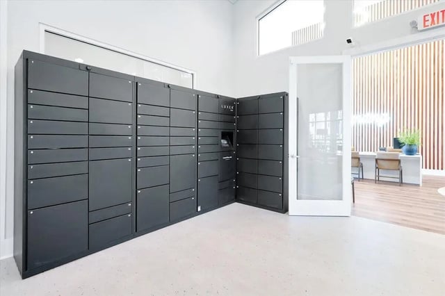 Luxer package lockers with numbered compartments mail area at Eagle Landing in Daytona Beach Student Accommodation