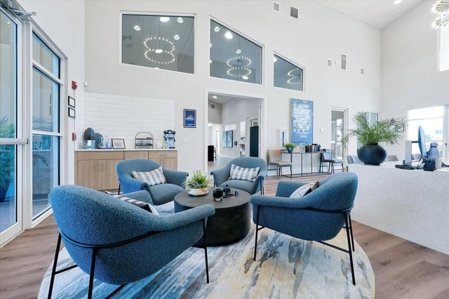 Four blue armchairs around coffee table lounge area at Eagle Landing in Daytona Beach Student Accommodation