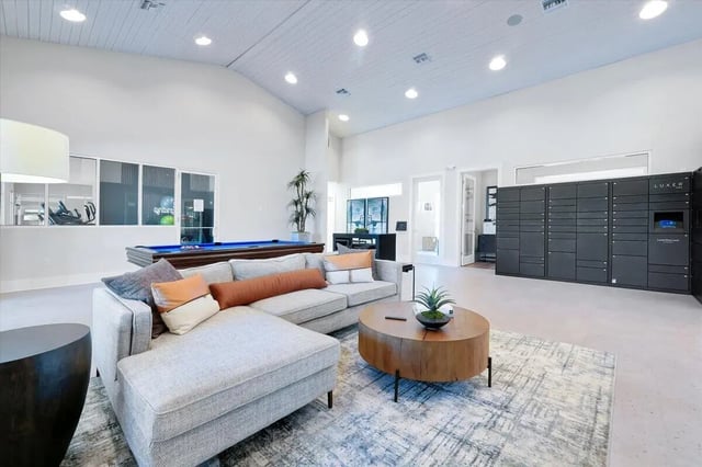 Sofa pool table lockers living room common area at Eagle Landing in Daytona Beach Student Accommodation