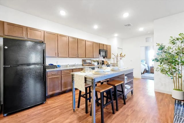 Black refrigerator kitchen island with stools kitchen at Eagle Landing in Daytona Beach Student Accommodation