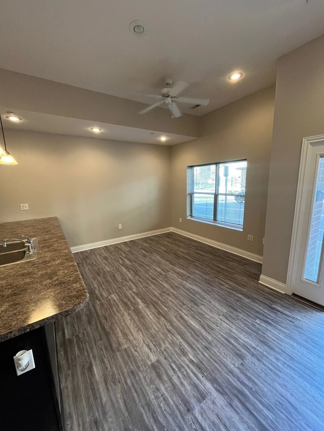 Kitchen counter sink and wood floor living room at 7 Ten Apartments in Bloomington Student Accommodation