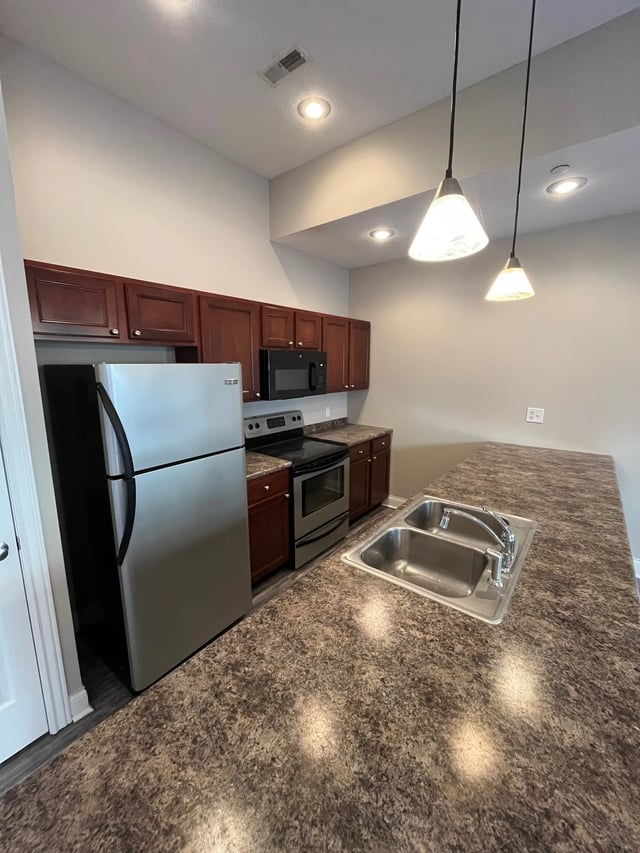 Refrigerator stove cabinets double sink kitchen at 7 Ten Apartments in Bloomington Student Accommodation