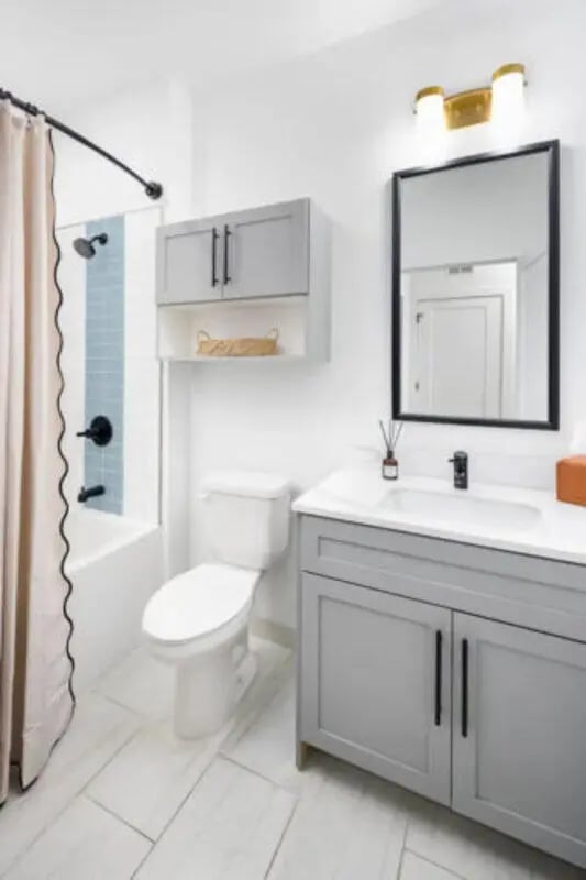 Toilet bathtub vanity mirror with cabinets bathroom at Prospect Row in Tallahassee Student Accommodation