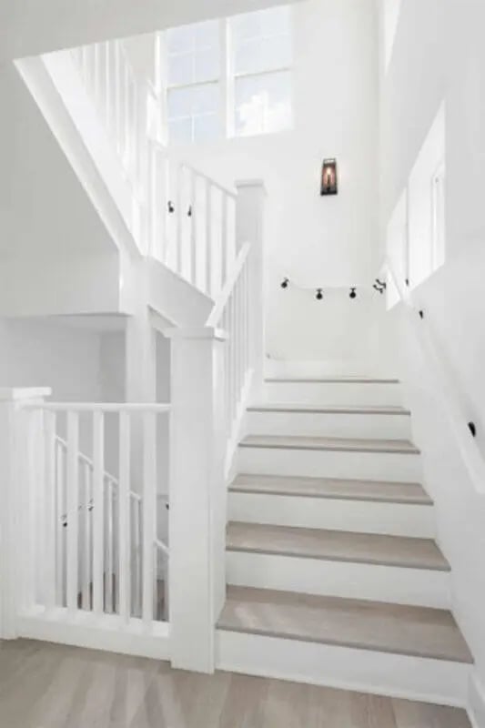 White staircase with grey steps and windows Staircase at Prospect Row in Tallahassee Student Accommodation