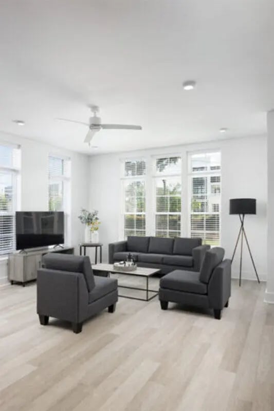 Sofa chairs coffee table TV living room at Prospect Row in Tallahassee Student Accommodation