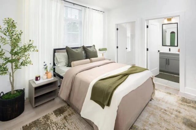 Bed with green pillows and throw bathroom visible bedroom at Prospect Row North in Tallahassee Student Accommodation