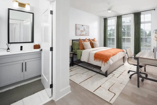 Bed with orange throw and desk bedroom and bathroom at Prospect Row North in Tallahassee Student Accommodation