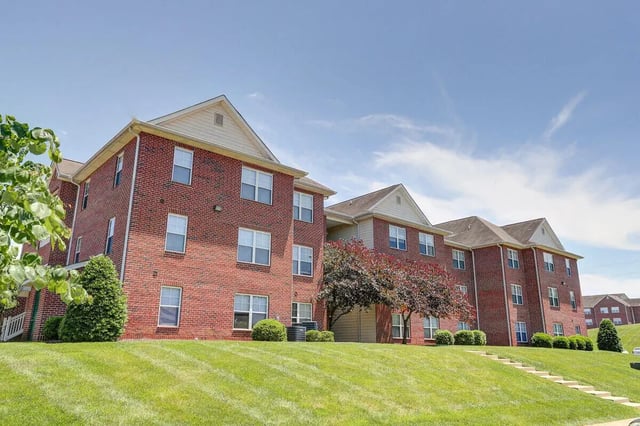Brick apartment buildings with grassy lawn exterior at Eagles Landing Apartments in Cookeville Student Accommodation