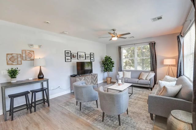 Living room with sofa chairs table and TV living room at Eagles Landing Apartments in Cookeville Student Accommodation
